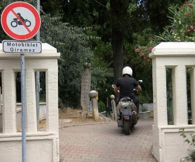 Yasak dinlemeyen motokuryeler mezarlıktaki yaya yolunu kullanıyor